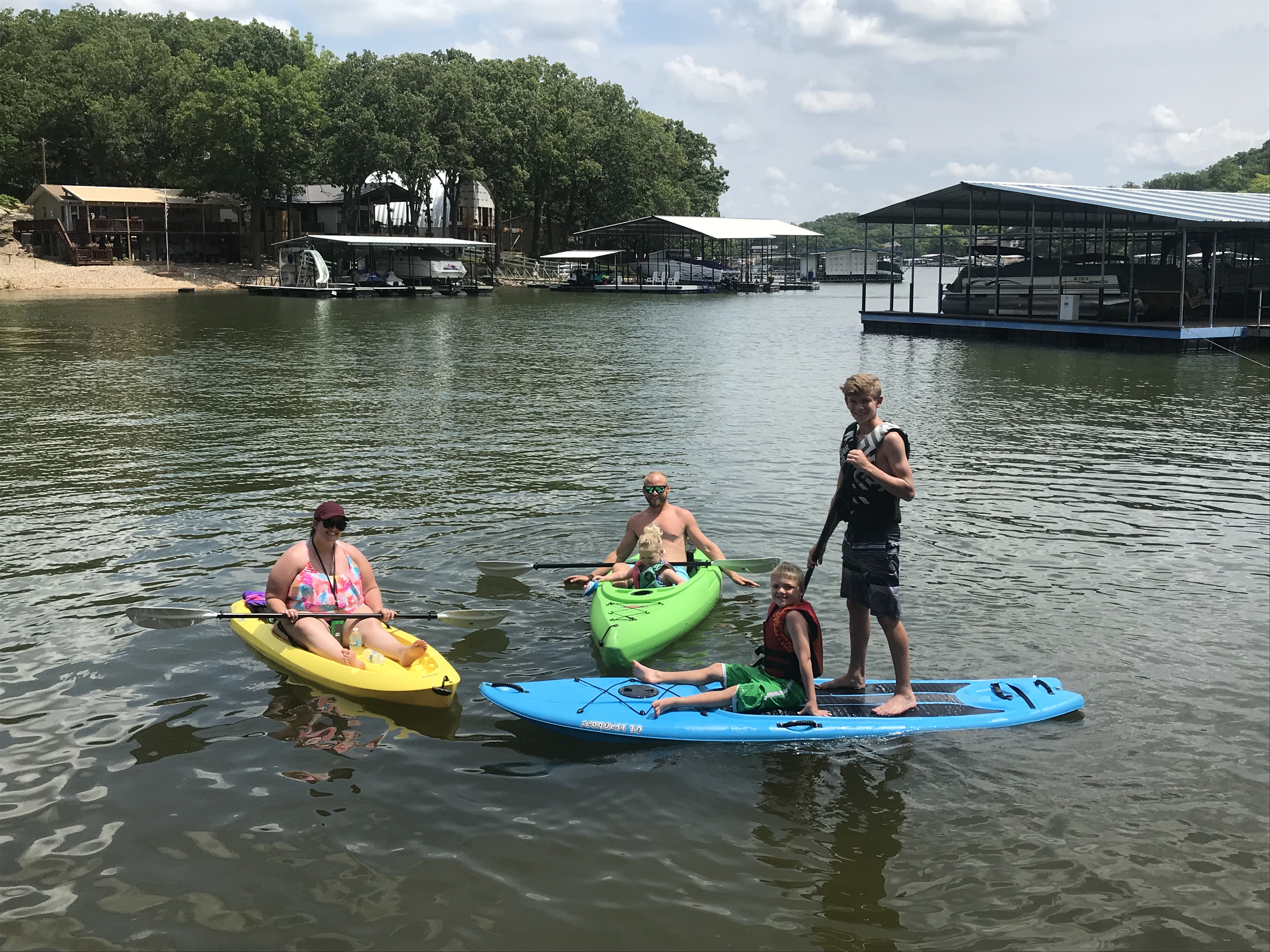 Family kayak and paddle boarding outing